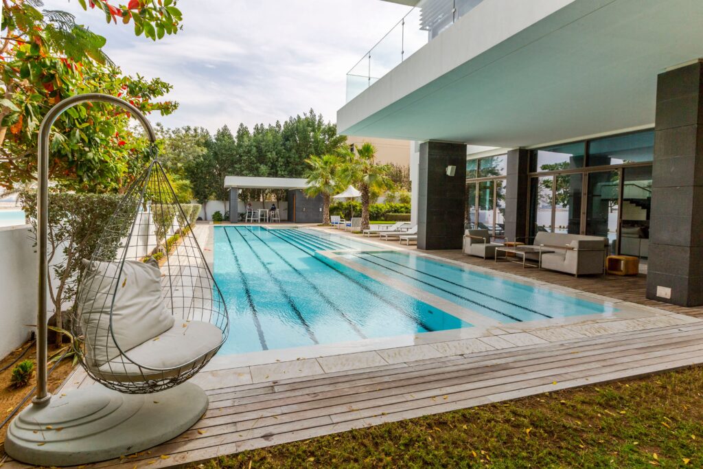 Explore a modern luxury villa featuring a sleek swimming pool and spacious terrace in Dubai.