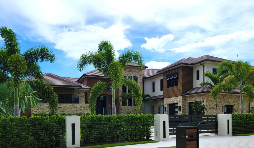 A modern and luxurious house surrounded by lush palm trees, perfect for real estate showcasing.